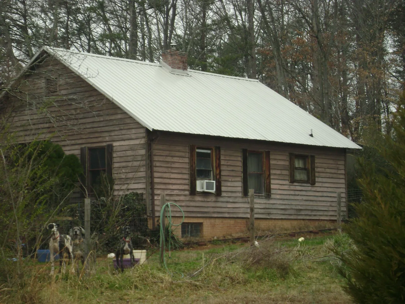 White metal roof on an old wood sided farmhouse, from a Metal Roof Installation job in Carver
